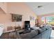 Cozy living room featuring wood flooring, high ceilings, wet bar, and a comfortable seating area at 3910 77Th E Pl, Sarasota, FL 34243