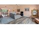 Comfortable living room with wood floors, wet bar, open floor plan, and lots of natural light at 3910 77Th E Pl, Sarasota, FL 34243