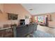 Cozy living room with vaulted ceiling, large window, wood floors and gray sofa at 3910 77Th E Pl, Sarasota, FL 34243