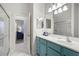 Bright bathroom with a colorful teal vanity, large mirror, and access to the living area at 4103 61St E Ave, Bradenton, FL 34203