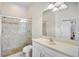 Bright bathroom featuring a glass door shower, a toilet, and a vanity with a white cabinet at 4103 61St E Ave, Bradenton, FL 34203