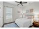 This bedroom has hardwood floors, a ceiling fan, and a well-lit window with curtains at 4103 61St E Ave, Bradenton, FL 34203