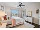 Comfortable bedroom with a ceiling fan, natural light, and a view of the backyard at 4103 61St E Ave, Bradenton, FL 34203