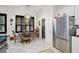 Cozy eat-in kitchen features a dining table, stainless refrigerator, and laundry access at 4103 61St E Ave, Bradenton, FL 34203