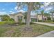 Beautifully landscaped front yard showcasing lush greenery, a well-maintained lawn, and mature trees at 4103 61St E Ave, Bradenton, FL 34203