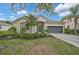 Charming single-story home featuring a well-manicured lawn, lush landscaping, and a two-car garage at 4103 61St E Ave, Bradenton, FL 34203