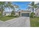 Well maintained property with a spacious driveway leading to an attached garage, framed by lush landscaping at 4103 61St E Ave, Bradenton, FL 34203