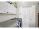 A laundry room with a washer and dryer, white cabinets, and a neatly organized space at 4103 61St E Ave, Bradenton, FL 34203
