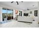 Bright living room with tile flooring, neutral paint, and a modern ceiling fan at 4103 61St E Ave, Bradenton, FL 34203