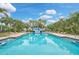 Community pool with clear blue water and a slide at 4103 61St E Ave, Bradenton, FL 34203