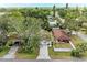 Aerial view of a neighborhood street with homes and lush greenery surrounding the properties at 4115 2Nd Nw Ave, Bradenton, FL 34209