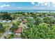 Aerial view of a home surrounded by lush greenery and trees, with a glimpse of the ocean in the distance at 4115 2Nd Nw Ave, Bradenton, FL 34209