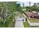 An overhead view of the home, showcasing the driveway and surrounding trees at 4115 2Nd Nw Ave, Bradenton, FL 34209