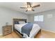 Bedroom with wood floors, large bed, ceiling fan, natural light, and neutral colored walls at 4115 2Nd Nw Ave, Bradenton, FL 34209