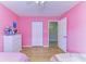 Spacious bedroom with wood-look flooring, open closet, and view to the next room at 4115 2Nd Nw Ave, Bradenton, FL 34209