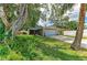 Charming single-story home with a well-manicured lawn, mature trees, and a two-car garage on a sunny day at 4115 2Nd Nw Ave, Bradenton, FL 34209