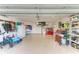 Well-lit garage featuring epoxy flooring, a washer and dryer, and ample storage space at 4115 2Nd Nw Ave, Bradenton, FL 34209