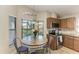 Eat-in kitchen features a round table, stainless steel appliances, tile backsplash, and a view to the outside at 4115 2Nd Nw Ave, Bradenton, FL 34209
