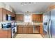 Well-lit kitchen featuring wooden cabinets, stainless steel appliances, granite countertops, and tiled backsplash at 4115 2Nd Nw Ave, Bradenton, FL 34209