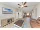 Open living space with wood-look tile, a ceiling fan, and views into the kitchen, creating an inclusive and comfortable atmosphere at 4115 2Nd Nw Ave, Bradenton, FL 34209