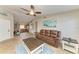 Open-concept living room featuring tile floors, a leather sofa, and a seamless transition to the kitchen, creating a welcoming space at 4115 2Nd Nw Ave, Bradenton, FL 34209