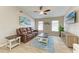 Well-lit living room with tile floors, leather seating, and tasteful decor, creating a warm and inviting ambiance for gatherings at 4115 2Nd Nw Ave, Bradenton, FL 34209