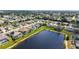 Aerial view of home overlooking lake with pool at 4274 Tennyson Way, Venice, FL 34293