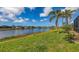 Beautiful lake view and green lawn in backyard at 4274 Tennyson Way, Venice, FL 34293