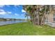 Lush green backyard with lake view and mature landscaping at 4274 Tennyson Way, Venice, FL 34293