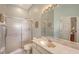 Bathroom featuring walk-in shower, toilet, large mirror and single sink at 4274 Tennyson Way, Venice, FL 34293