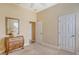 Bedroom with a decorative lamp, ample closet space, and neutral carpet at 4274 Tennyson Way, Venice, FL 34293