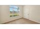 Bedroom with a large window offering neighborhood views and natural light at 4274 Tennyson Way, Venice, FL 34293
