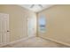This bedroom features neutral walls, carpet flooring, a ceiling fan, and a window for natural light at 4274 Tennyson Way, Venice, FL 34293