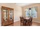 Dining room with wood flooring, dining set, and a view of the window at 4274 Tennyson Way, Venice, FL 34293