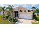 Charming single Gathering home boasts a lush landscaped yard and attached two car garage at 4274 Tennyson Way, Venice, FL 34293