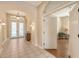 The foyer is spacious with tile flooring, arched doorways, and a decorative light fixture at 4274 Tennyson Way, Venice, FL 34293