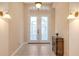 Bright foyer featuring tile flooring, decorative sconces, and a frosted glass double door at 4274 Tennyson Way, Venice, FL 34293
