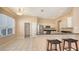 Cozy kitchen with bar seating area, stainless appliances, and an open view to dining area at 4274 Tennyson Way, Venice, FL 34293