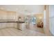Open kitchen flows to an adjacent living area with access to the lanai and outdoor pool at 4274 Tennyson Way, Venice, FL 34293
