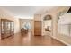 Open living room with wood floors, formal dining area, and decorative doorway at 4274 Tennyson Way, Venice, FL 34293