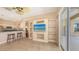 Open-concept living room with tile floors, breakfast bar and a large entertainment center at 4274 Tennyson Way, Venice, FL 34293