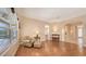 Comfortable living room with wood flooring and access to other areas of the house at 4274 Tennyson Way, Venice, FL 34293