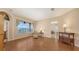 Elegant living room with wood flooring and a view of the screened-in pool area at 4274 Tennyson Way, Venice, FL 34293