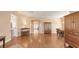 Spacious living room with wood flooring, open layout, and formal dining area at 4274 Tennyson Way, Venice, FL 34293
