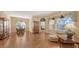 Elegant living room with wood flooring, formal dining area, and cozy seating area at 4274 Tennyson Way, Venice, FL 34293