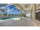 Screened-in pool area with lake view and covered patio at 4274 Tennyson Way, Venice, FL 34293