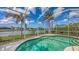 Screened pool with beautiful lake view and palm trees in backyard at 4274 Tennyson Way, Venice, FL 34293