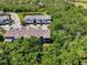 An aerial shot showcases the property's location amidst lush greenery and serene surroundings at 4500 Chinkapin Dr, Sarasota, FL 34232