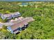 The building is surrounded by trees and greenery, with a body of water in the background at 4500 Chinkapin Dr, Sarasota, FL 34232