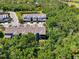 An aerial shot showcases the property's location amidst lush greenery and serene surroundings at 4500 Chinkapin Dr, Sarasota, FL 34232